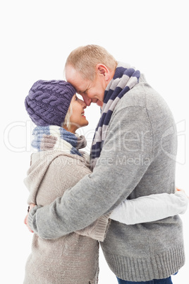 Happy mature couple in winter clothes hugging