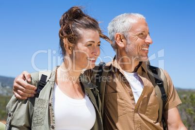 Hiking couple smiling together on mountain trail