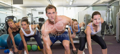 Muscular instructor leading kettlebell class