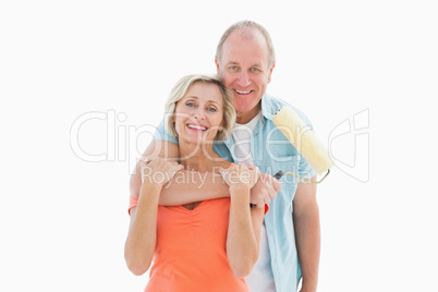 Happy older couple holding paint roller