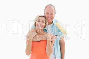 Happy older couple holding paint roller