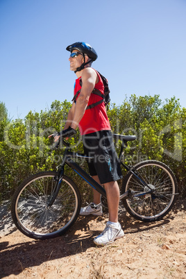 Fit man cycling on mountain trail