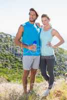 Fit couple standing at summit