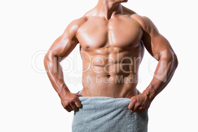 Mid section of a shirtless muscular man in white towel