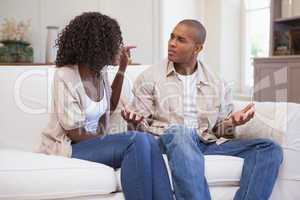 Unhappy couple arguing on the couch