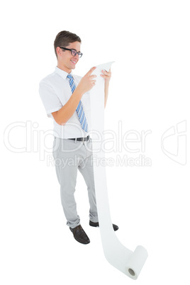 Geeky happy businessman reading a long receipt