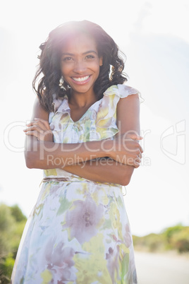 Beautiful woman in floral dress smiling at camera