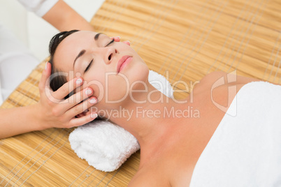 Peaceful brunette enjoying a head massage