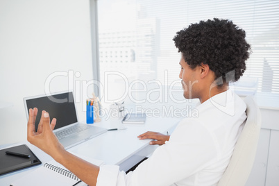 Happy businessman working at his desk