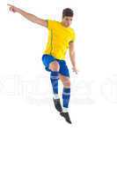 Football player in yellow kicking