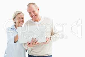 Happy mature couple using laptop