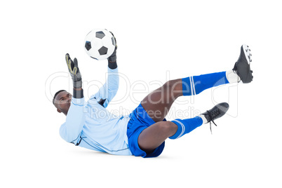 Goalkeeper in blue making a save