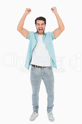 Happy casual man cheering at camera