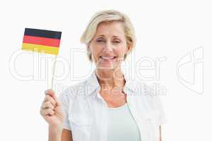 Happy mature woman holding german flag