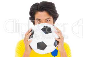 Football player in yellow holding ball