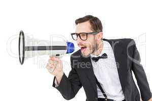 Geeky businessman shouting through megaphone