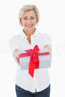 Mature blonde smiling at camera holding gift