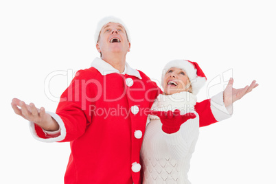 Festive couple smiling and looking up