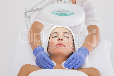 Hands cleaning womans neck with cotton swabs