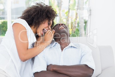 Attractive couple cuddling on the couch