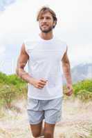 Attractive man jogging on mountain trail
