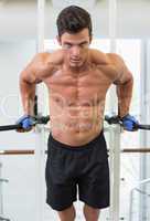Muscular man doing crossfit fitness workout in gym