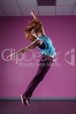 Pretty break dancer leaping mid air