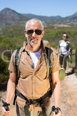 Happy hiking couple walking on mountain trail