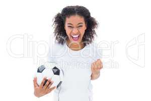 Pretty football fan in white cheering at camera