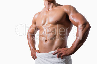 Mid section of a shirtless muscular man in white towel