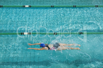 Female swimmer training by herself