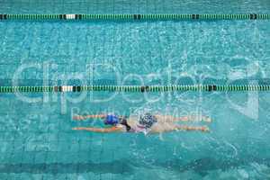 Female swimmer training by herself