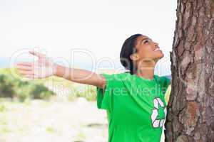 Pretty environmental activist looking up at tree
