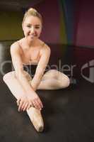 Ballerina sitting and smiling at camera