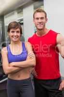 Fit attractive couple smiling at camera