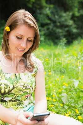 Woman text messaging in field