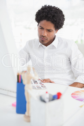 Hipster photo editor working at his desk