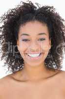 Pretty girl with afro hairstyle smiling at camera