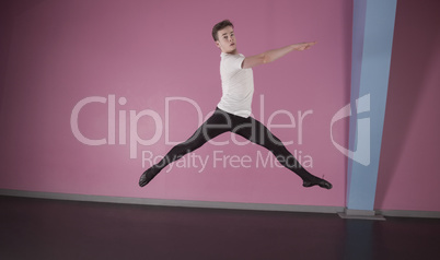 Focused male ballet dancer leaping