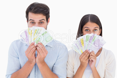 Happy couple showing their money