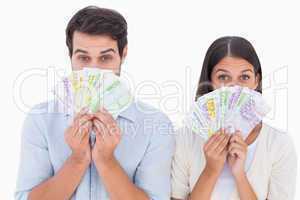 Happy couple showing their money