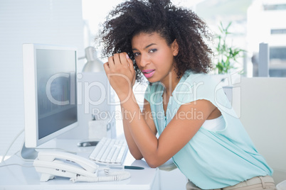 Casual businesswoman stressing out at her desk