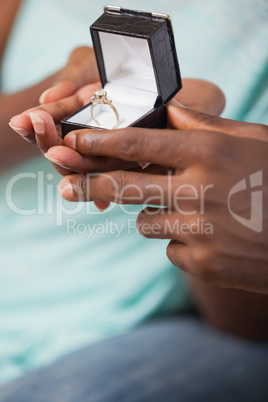 Man holding engagement ring in box