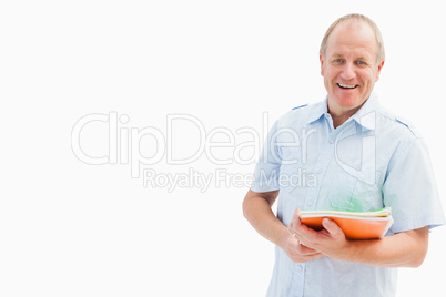 Happy mature student holding notebooks