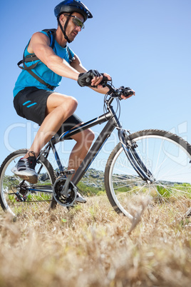 Fit cyclist riding in the countryside