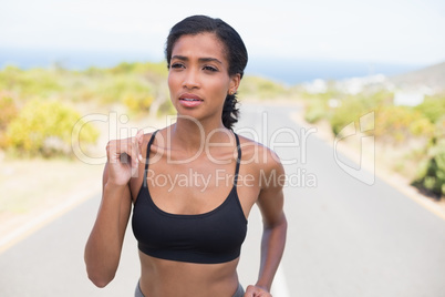 Fit woman running along the open road