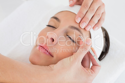 Hand applying eyeshadow to beautiful woman