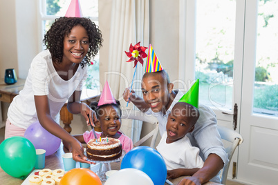 Happy family celebrating a birthday together at table