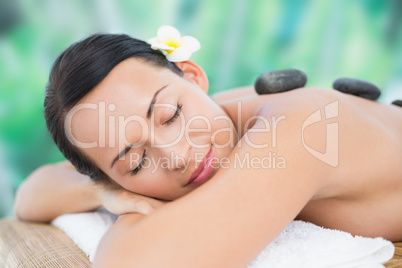 Beautiful brunette enjoying a hot stone massage