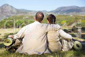 Hiking couple sitting and admiring the scenery